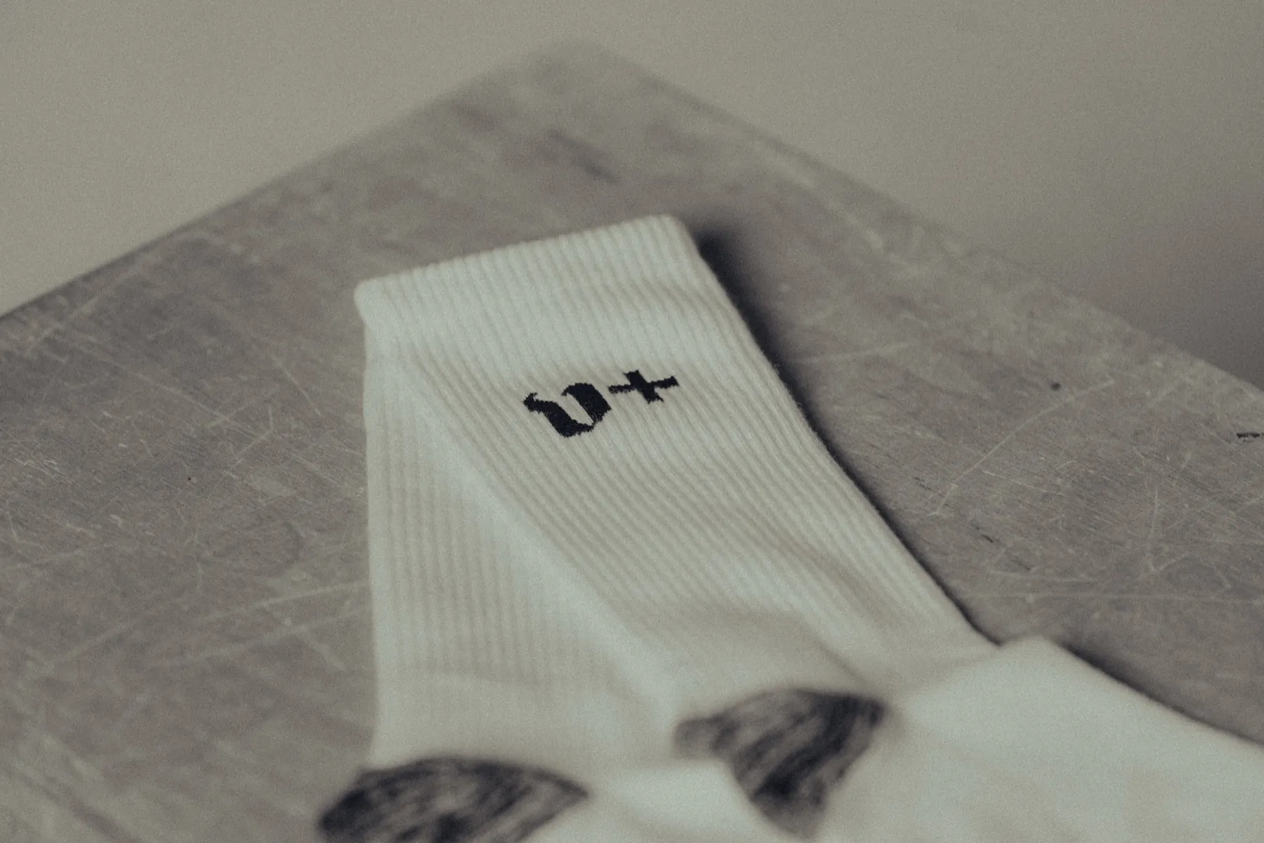 The v+ mark knitted at the cuff