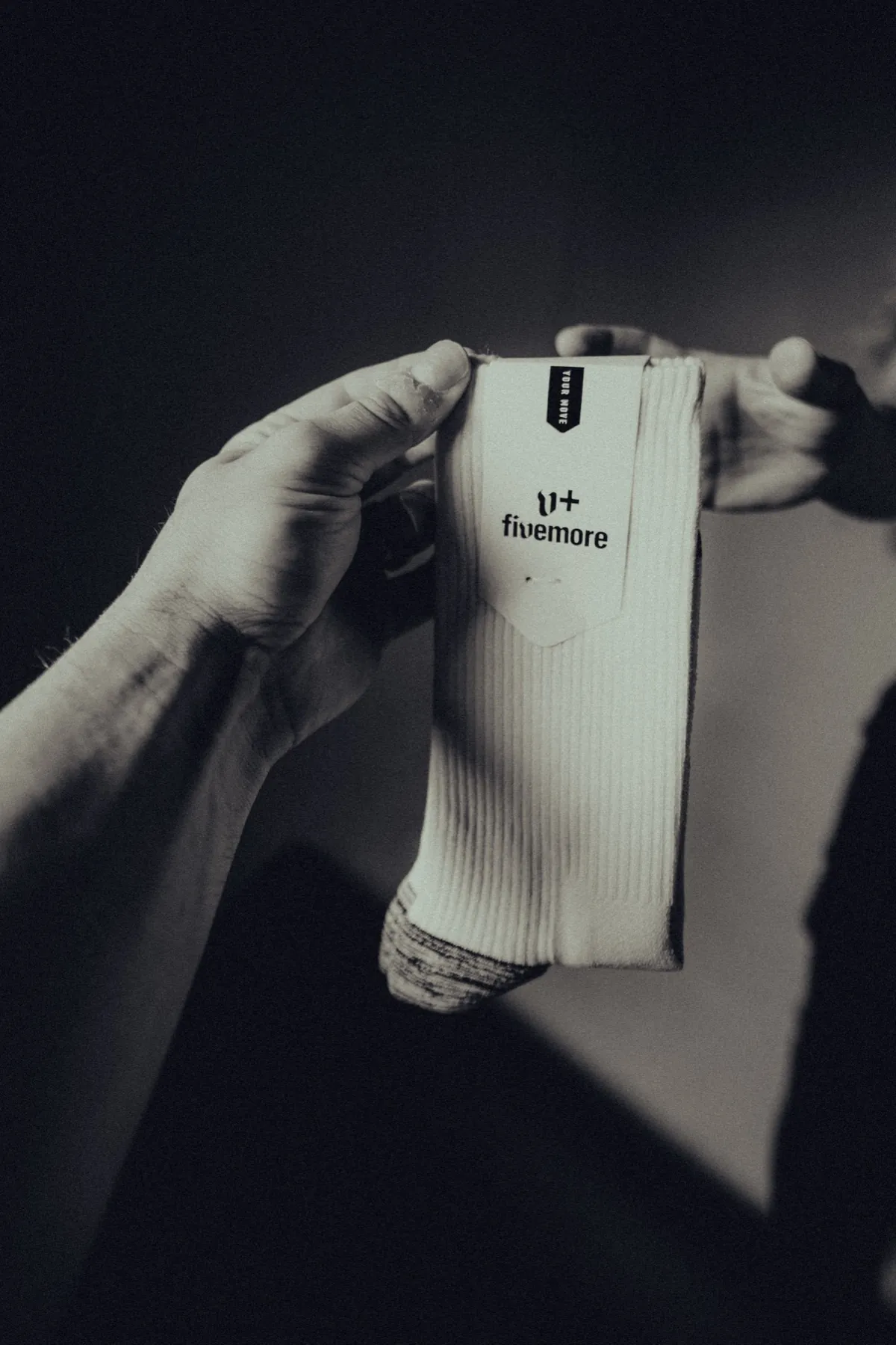 The packaged pair held in two hands